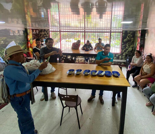 Coffee growers participating in a coffee quality training session at a laboratory in Tolima, Colombia.